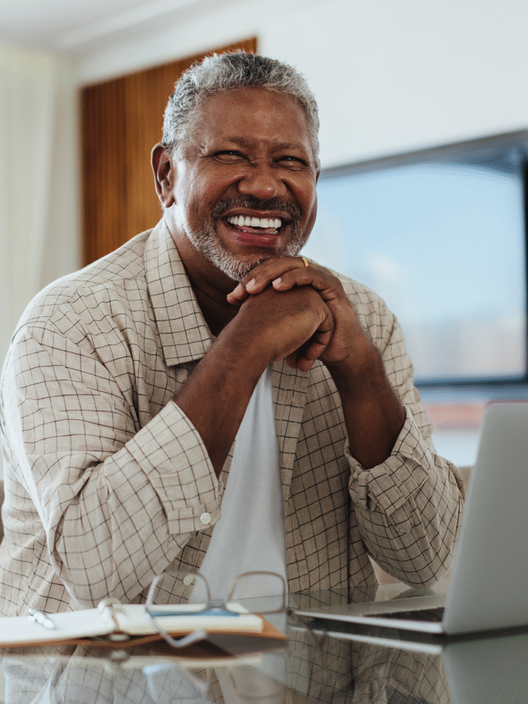 Patient smiling after full-arch dental implant treatment